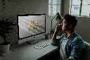 Man-using-iMac-Mockup-PSD white.webp